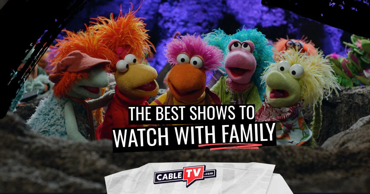 Five multicolored Fraggles stand shoulder-to-shoulder talking.