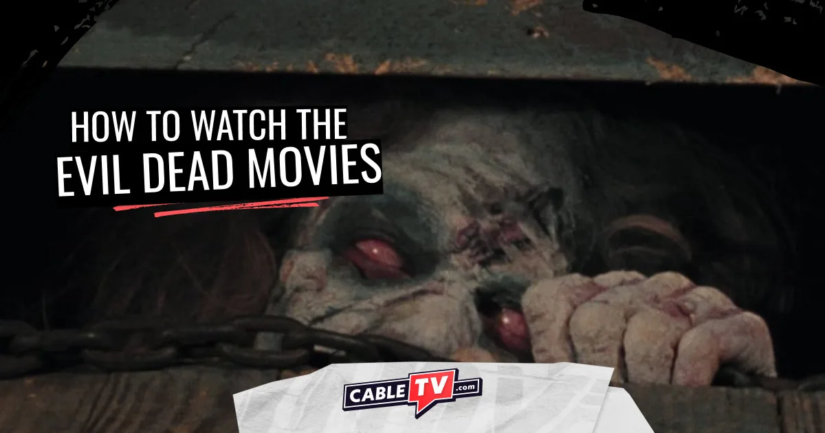 Image of a withered demon with cloudy eyes trying to escape through a cellar door hatch. A scene from The Evil Dead (1981).
