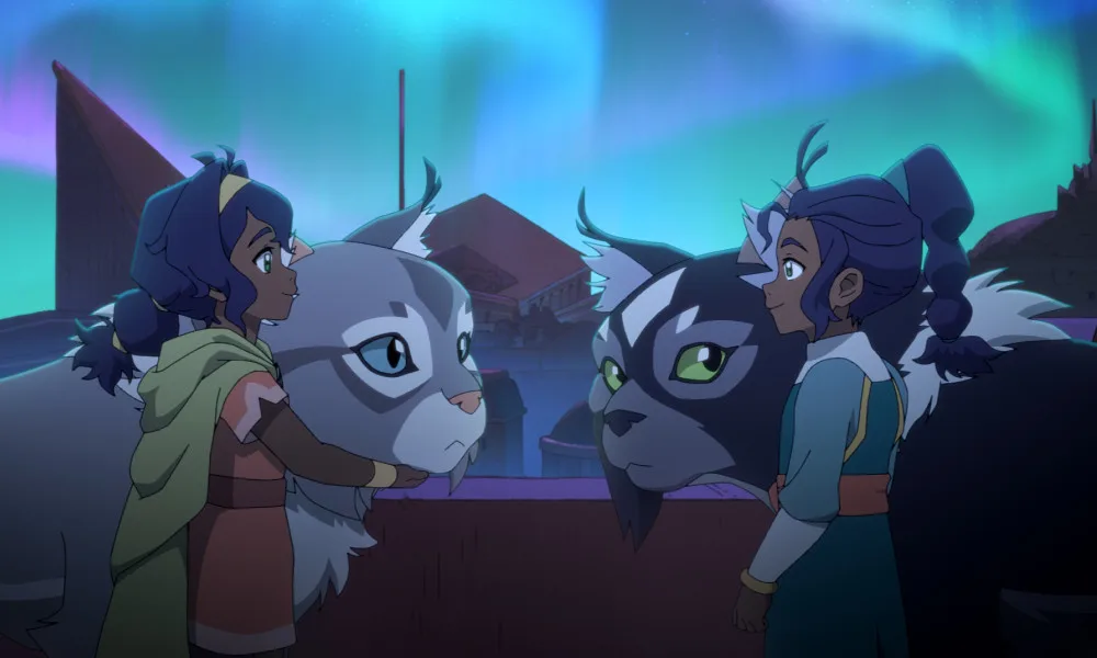 Two young twin girls, Pavi and Nisha, look at each other from either side of the frame. They stand with their near-identical cat-monkeys, Geet and Ruhi.