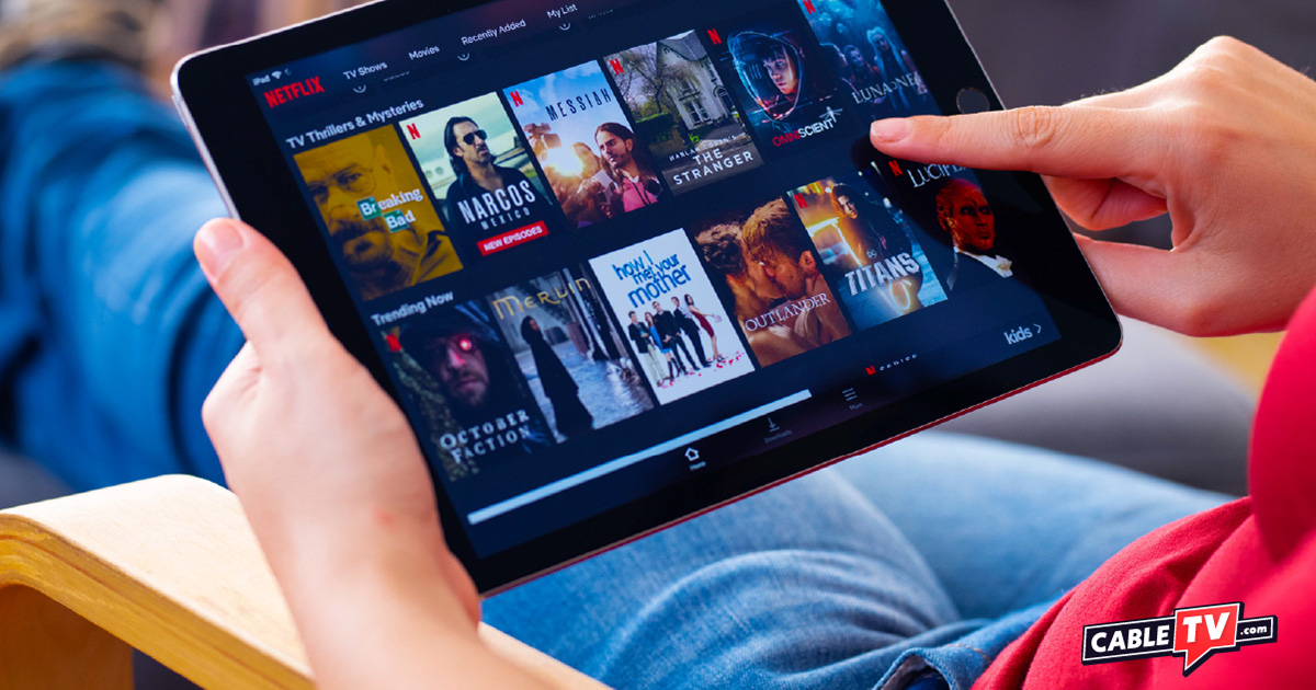 A person browsing Netflix on a tablet