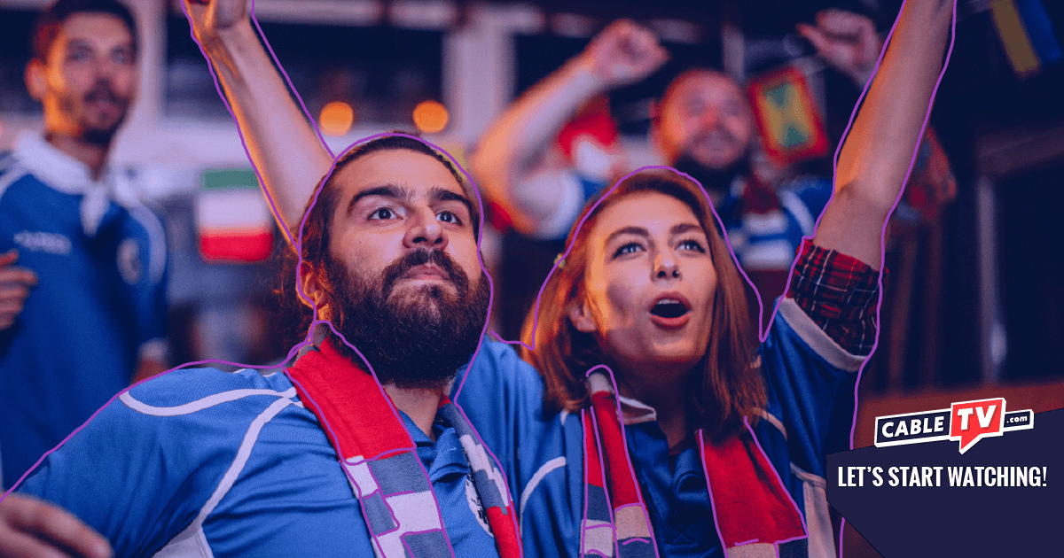 Man and woman cheering at a sporting event