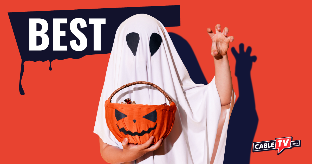 Child in ghost costume holding pumpkin candy bucket