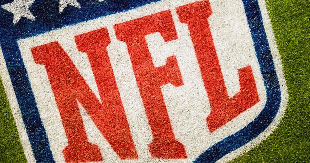 NFL logo on an artificial turf field.