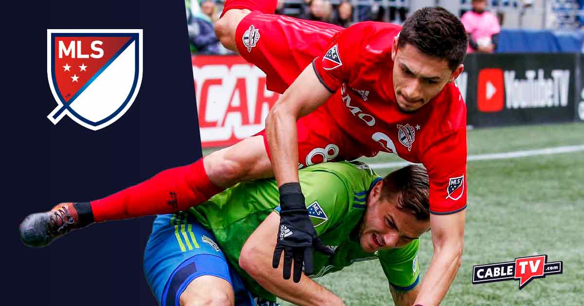 Seattle Sounders FC and Toronto FC players tackle each other during the MLS Cup Final.