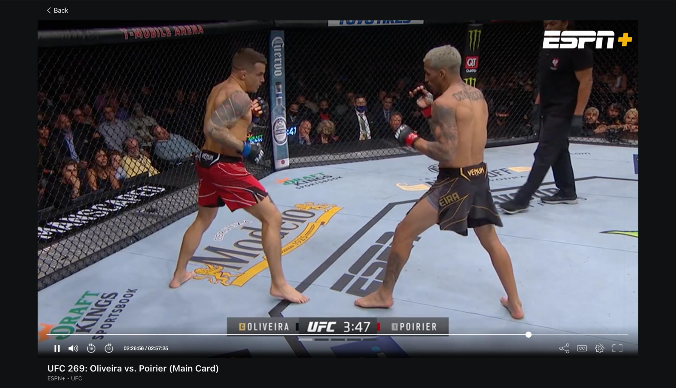 A screenshot of the ESPN Plus media player showing fighters Charles Oliveria and Dustin Poirier facing off in the UFC Octagon.