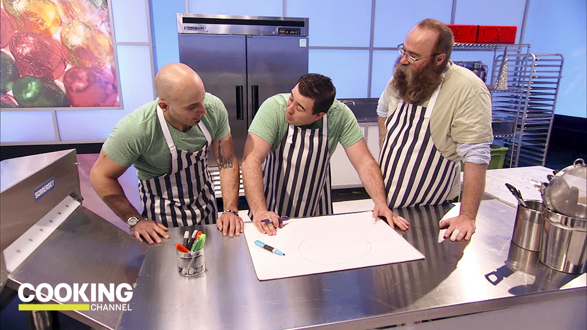 Three men planning a dish from a cooking competition show on The Cooking Channel.