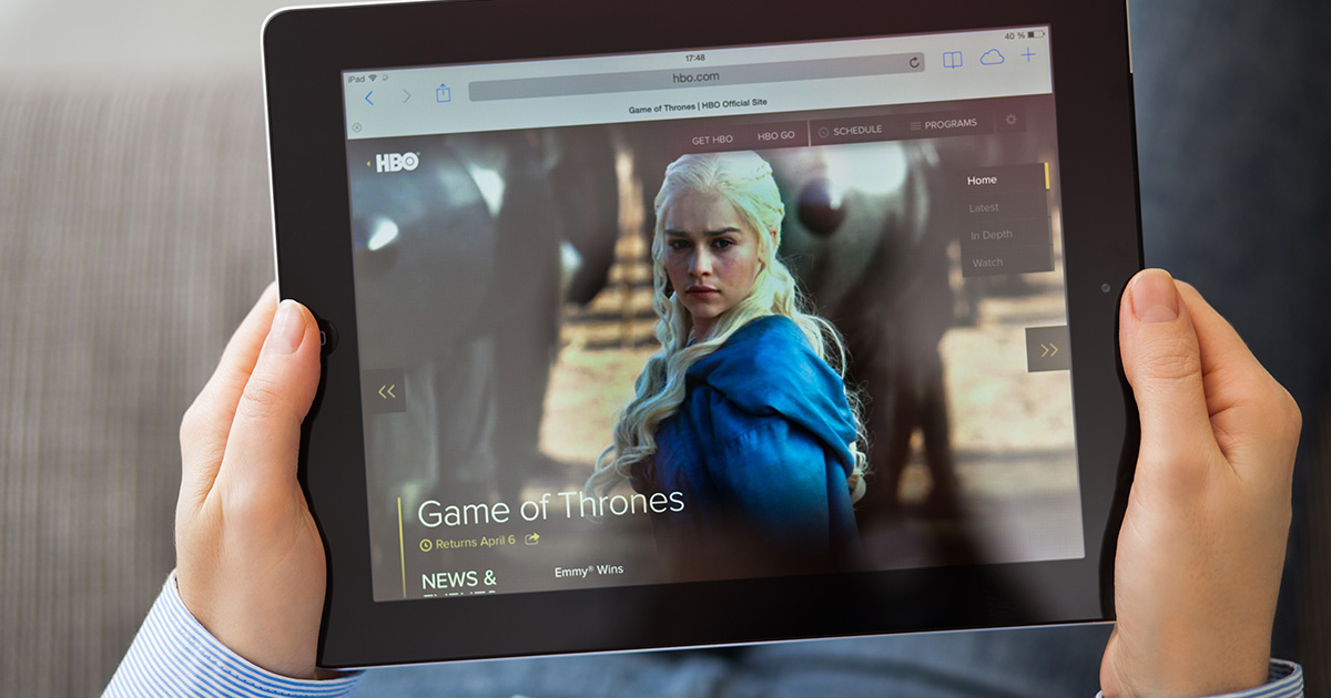 Person holding tablet with HBO website