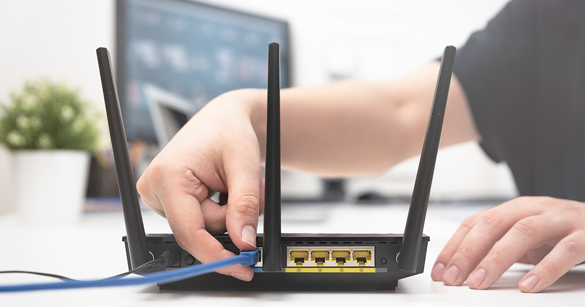 Person plugging in a router