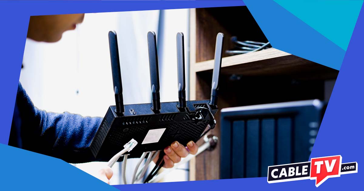 Person holding a router with multiple cords attached